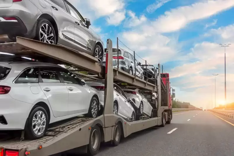 photo of a car shipping carrier on the road