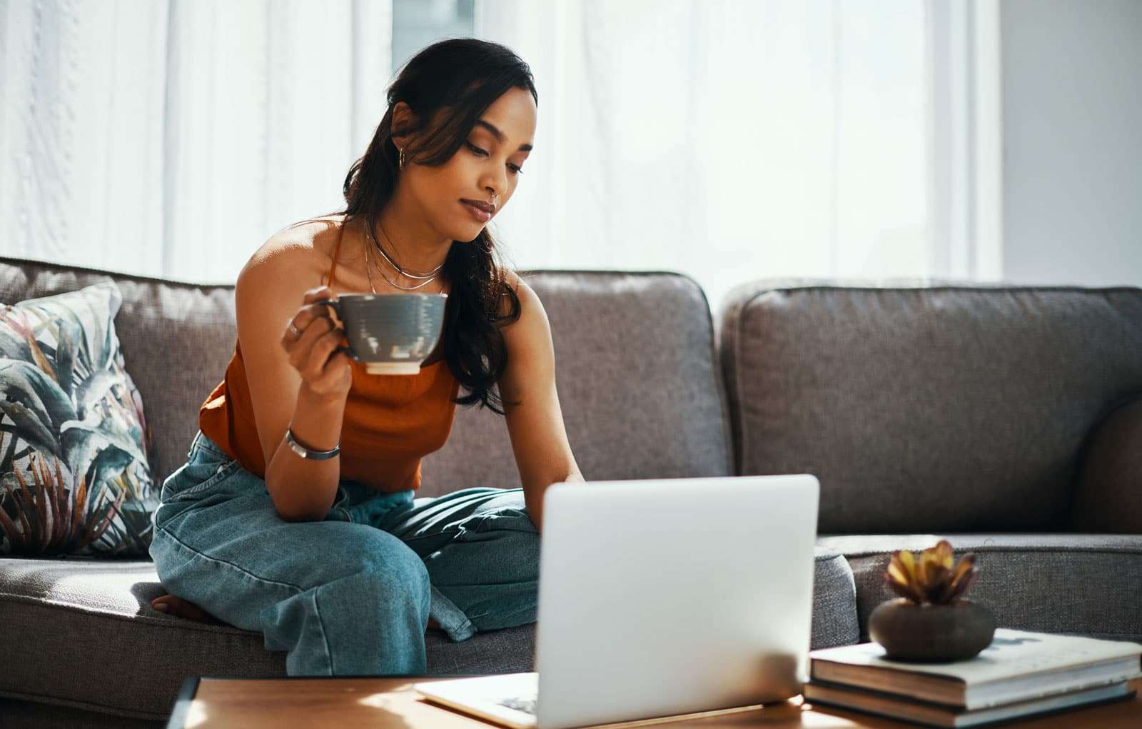 Woman looking online for car shipping cost