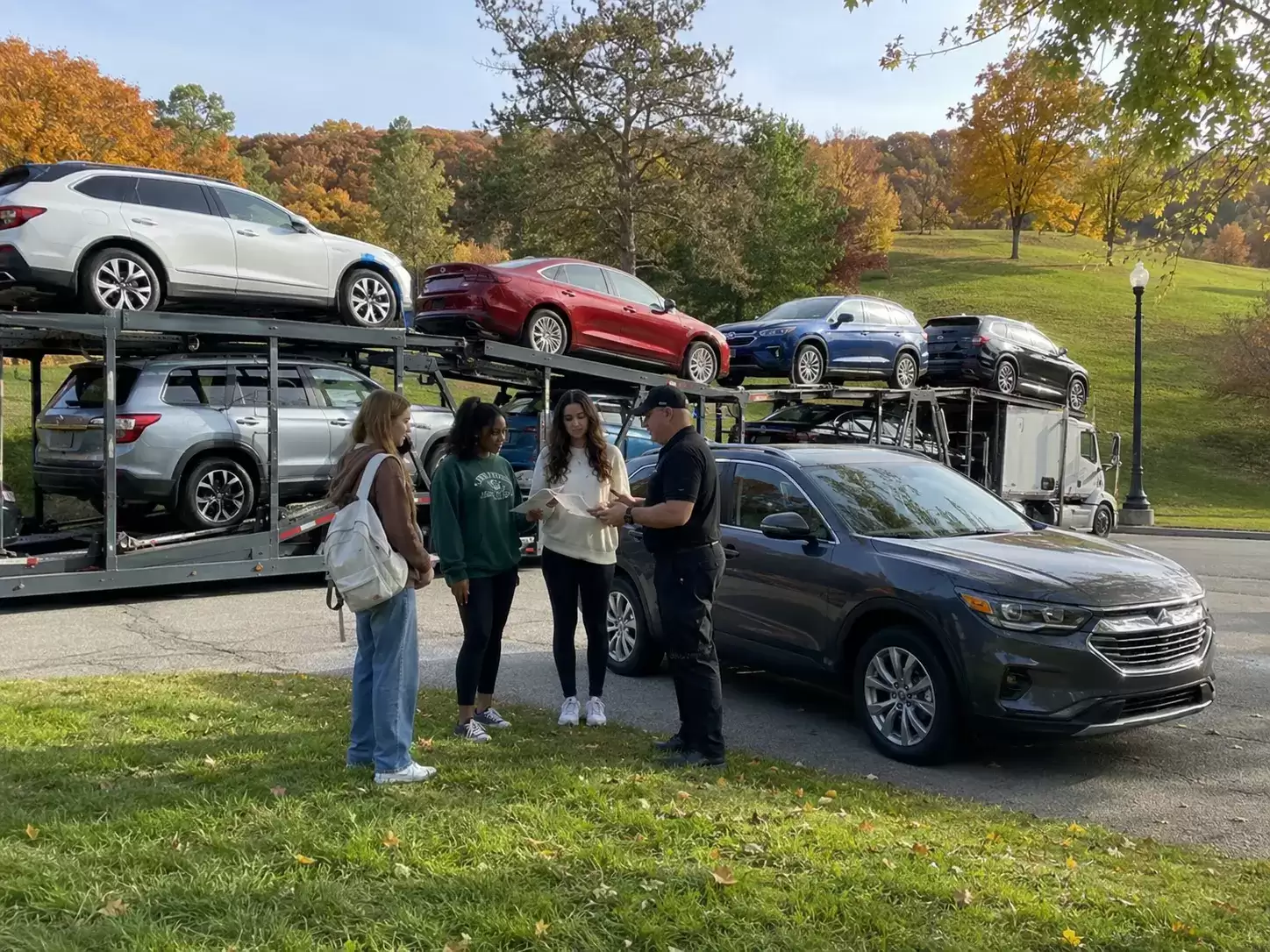 New York college students receiving a car transport shipment in a park
