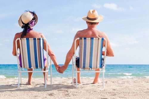 A couple on the beach after summer auto transport