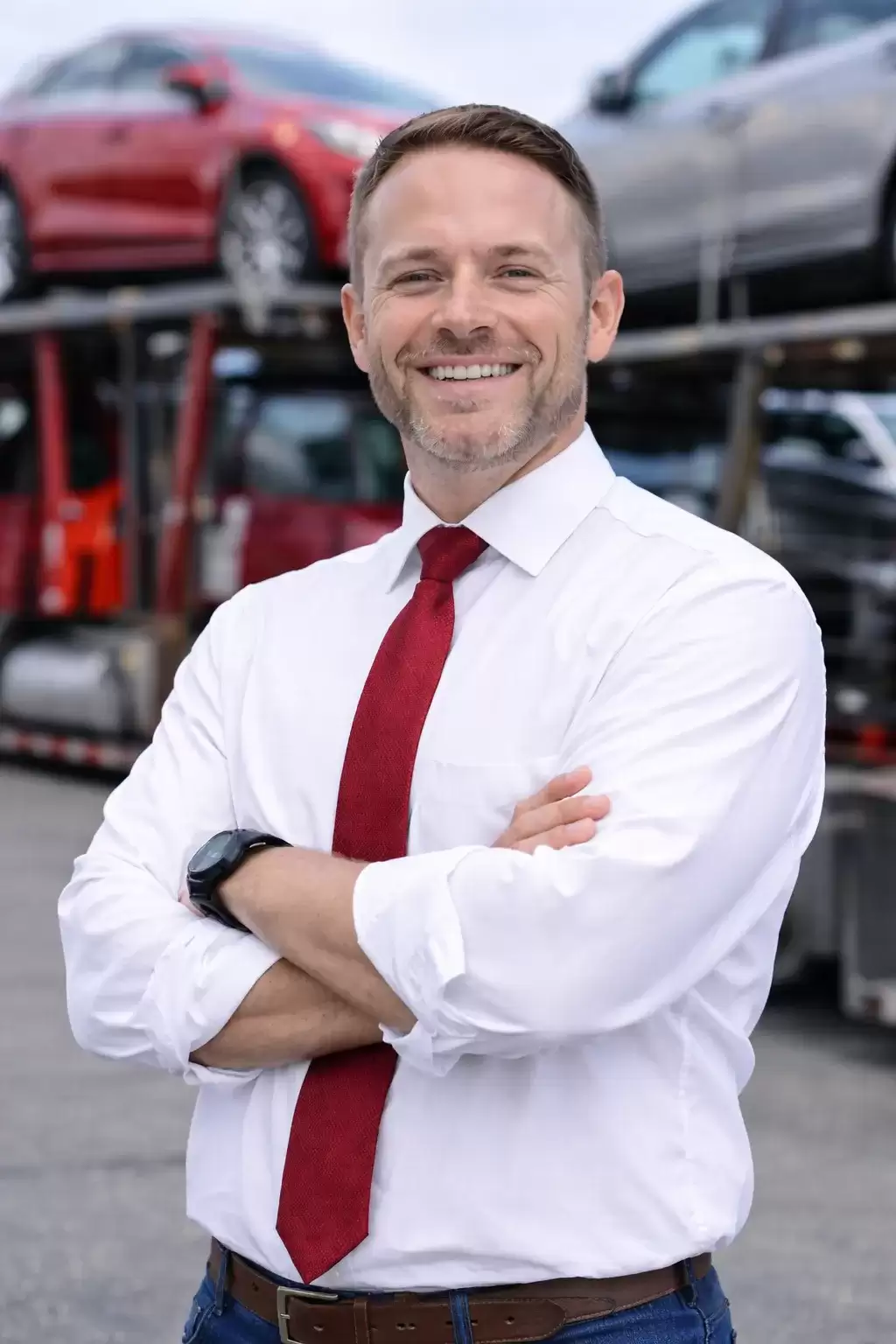 Illinois businessman in front of auto transport carrier