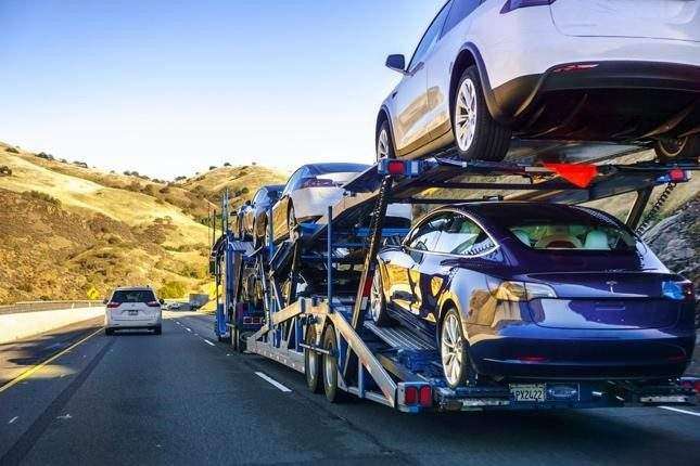 An Open-Air Car Transporter On The Road