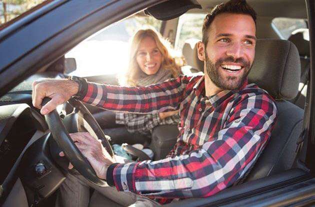 Is shipping a car a good idea? A young couple in their car.