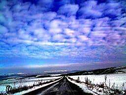 photo of a cold, snowy open road in the winter