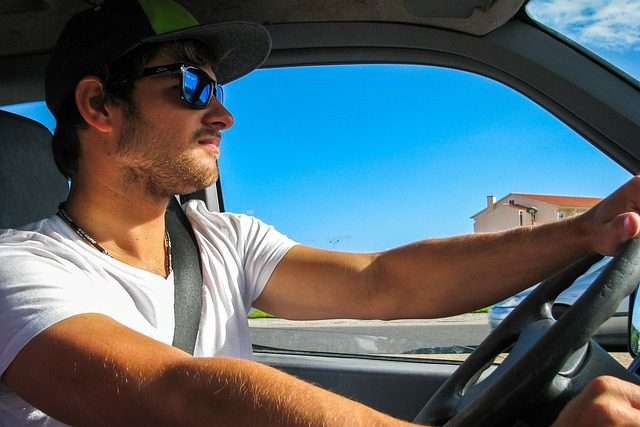 photo of young man driving and summer car shipping