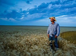 photo of a Kansas farmer in a wheat field